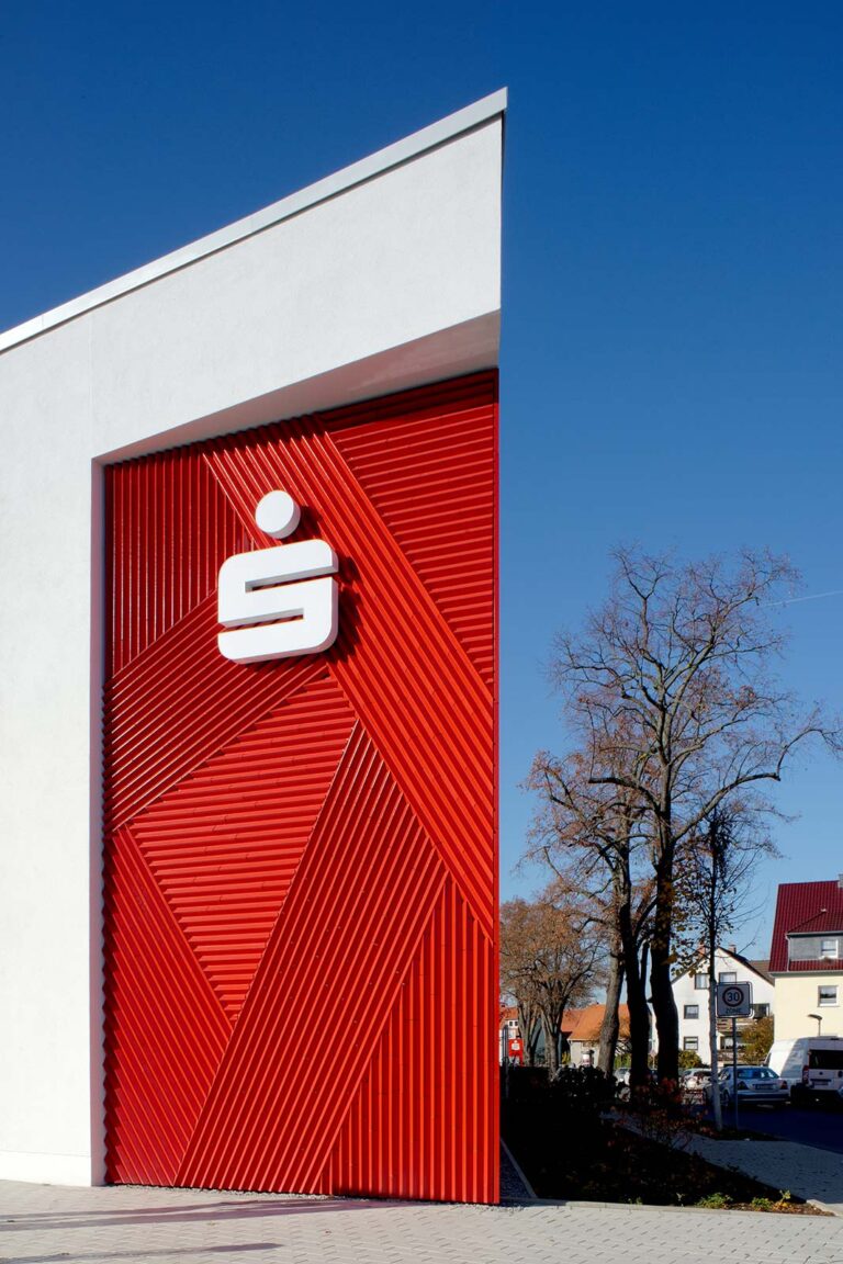 Neubau mit Betonkerntemperierung: Gebäudeecke mit Keramikfassade Die rote Keramikfassade am Neubau der Sparkassenfiliale Grone mit Betonkerntemperierung